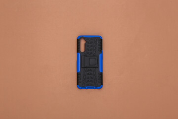 Protective case for smartphone on a brown background. Top view