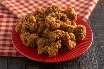 Fried and Crispy Chicken Gizzards on a Dark Wooden Table
