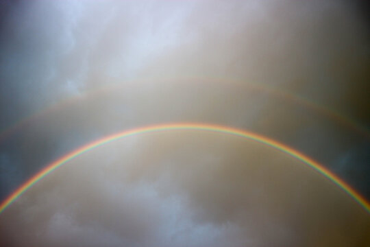 bright beautiful colorful double rainbow over the sea