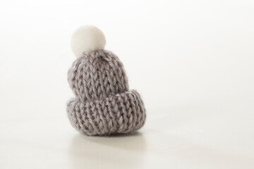  Grey winter woolen cap with pompon on white