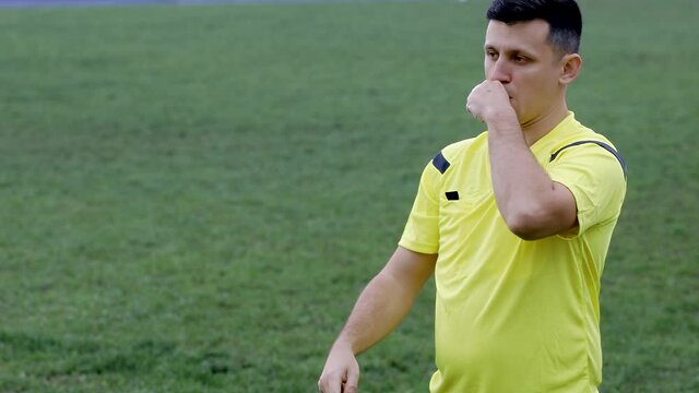 Referee goes watching VAR or violation of the rules and shows a penalty, yellow or red card . Concept of sport, rules violation, offside