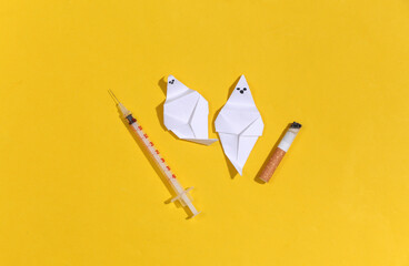 Smoking and drug addiction. Ghosts with cigarette and syringe on yellow background. Smoking and...
