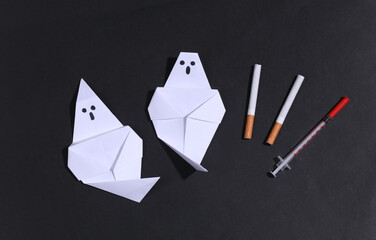 Smoking and drug addiction. Ghosts with cigarette and syringe on black dark background. Smoking and...