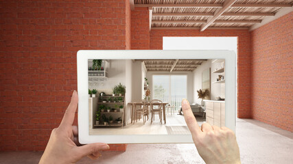 Augmented reality concept. Hand holding tablet with AR application used to simulate furniture and design products in interior construction site, cosy living room with dining table