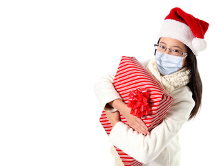 Fototapeta na wymiar Girl Wearing Santa Hat and Face Mask During Covid-19 Christmas Pandemic With Copy Space