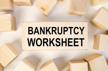 bankruptcy worksheet, text on wood block on white light background