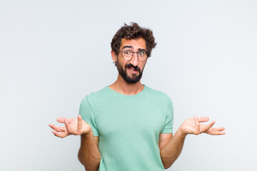 young bearded man feeling clueless and confused, not sure which choice or option to pick, wondering