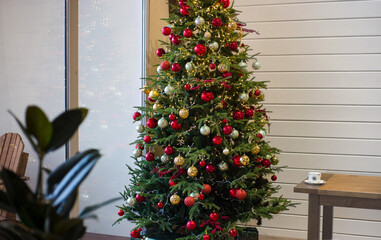 beautiful Christmas tree decorated with gold and red balls