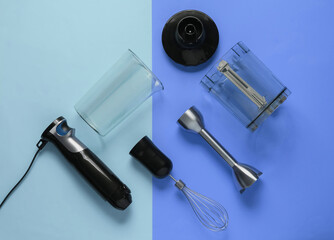 Electric hand mixer. Set of nozzles and containers for blender on blue pastel background. Top view, flat lay