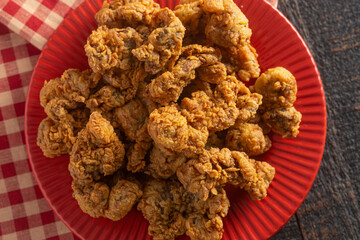 Fried and Crispy Chicken Gizzards on a Dark Wooden Table