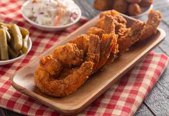 Breaded and Fried Jumbo Shrimp with Tails on a Wooden Table