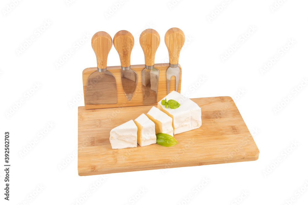 Wall mural Brie cheese with white mold on a board on a white background