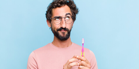 young bearded man scheming and conspiring, thinking devious tricks and cheats, cunning and betraying