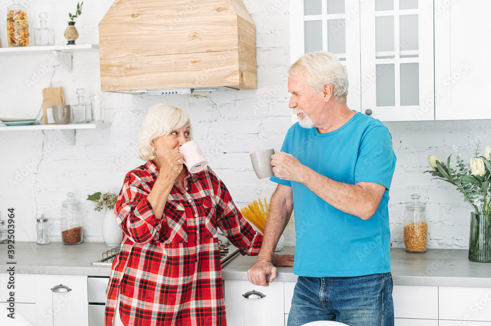 Wall mural Senior couple drinks tea in the kitchen