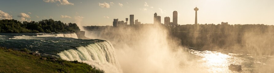 Side panorama view of american waterfalls with Niagara town and Niagara falls in background