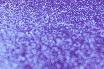 Abstract sparkling blured festive background with bokeh lights in trendy violet color for your creative design or greeting card. Festive concept or Christmas celebration