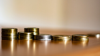 Coins stacked on each other in different positions. Money concept. Savings, inflation