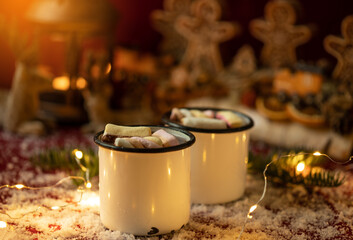 Hot chocolates surrounded with christmas decorations