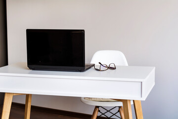 White wooden desk with laptop 