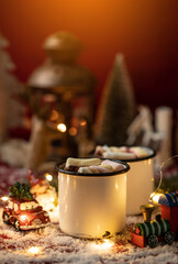 Hot chocolates surrounded with christmas decorations