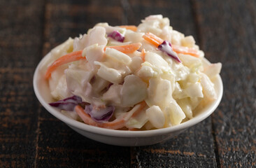 Bowl of Traditional Coleslaw on a Rustic Wooden Table