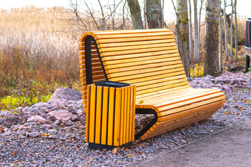 wooden bench and trash can in the Park