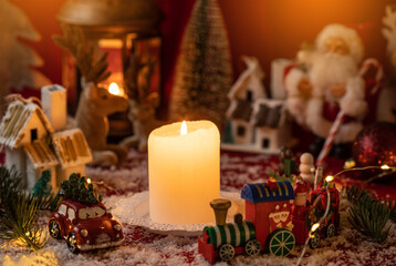 Candle surrounded with christmas decorations. Christmas country