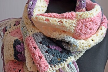 Multi-colored scarf, crocheted.Knitting in the patchwork style.