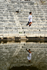 Young girl exploring an ruins of ancient city of Butrint.