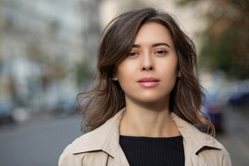 Closeup portrait of an elegant lady walking at the street