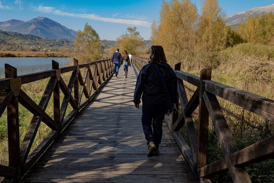 walk along the lake in a sunny autumn morning. Posta Fibreno, Frosinone. Wooden fence.