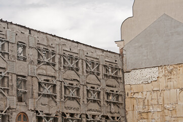 Strengthening of old facade wall of building with metal construction