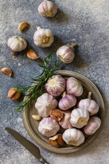 Healthy food. Garlic Cloves and Bulb on a stone or slate table. Top view flat lay background.