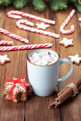 Christmas decoration with hot chocolate and gingerbread cookies on wooden table