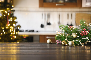 Wooden tabletop and Christmas decoration on blurred modern kitchen.