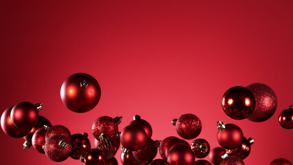 Fototapeta premium Flying christmas balls on coloured background