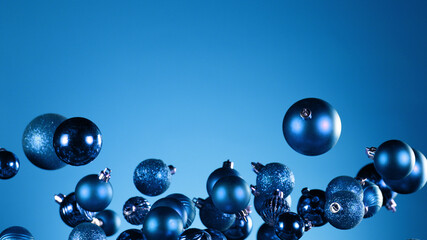 Flying christmas balls on coloured background