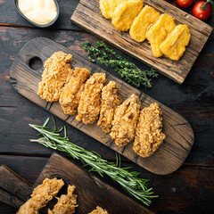 Southern fried chicken on dark wooden background, top view