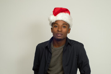 young african man wearing red christmas santa claus hat