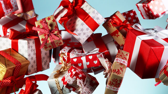Flying christmas gifts on coloured background