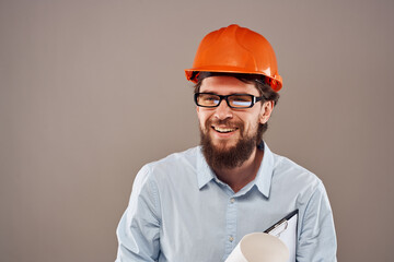 Cheerful man orange hard hat documents professional blueprints construction