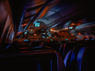 Dark aircraft cabin with red and blue lighting © fomyel