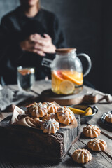 Woman is sitting with Hot tea with fresh grapefruit on wooden tablet. Healthy drink, Eco, vegan.