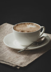 Delicious cappuccino in a cup on the table.