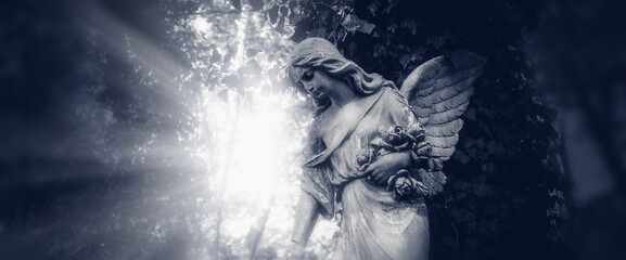 Fototapeta na wymiar Sad Angel of death.. Ancient statue. Horizontal image.