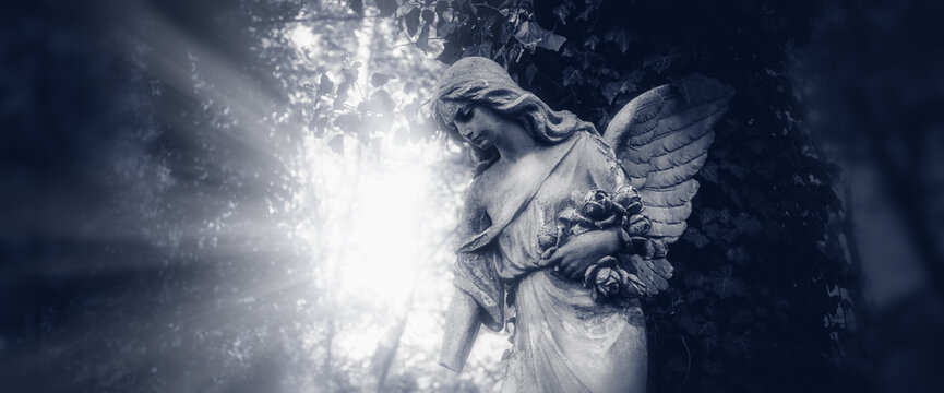 Sad Angel of death.. Ancient statue. Horizontal image.