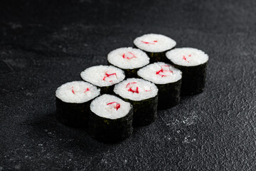 Sushi Rolls Set, maki, philadelphia and california rolls, on a Black background.