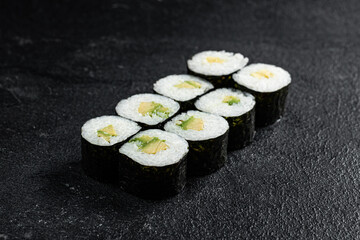 Sushi Rolls Set, maki, philadelphia and california rolls, on a Black background.