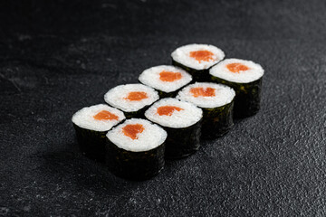 Sushi Rolls Set, maki, philadelphia and california rolls, on a Black background.