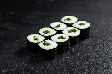 Sushi Rolls Set, maki, philadelphia and california rolls, on a Black background.